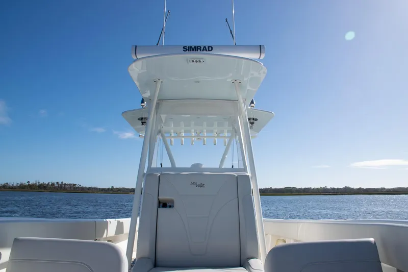Slide: The Image of 2022 SeaVee 322Z boat with Simrad electronics on calm water under clear blue sky. - 22