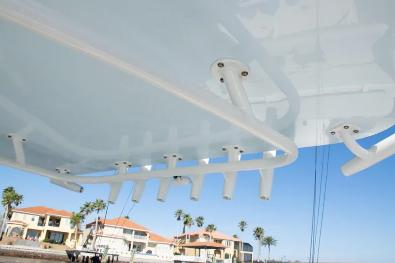 Slide: The Image of 2022 SeaVee 322Z boat with rod holders, coastal homes in background. - 23