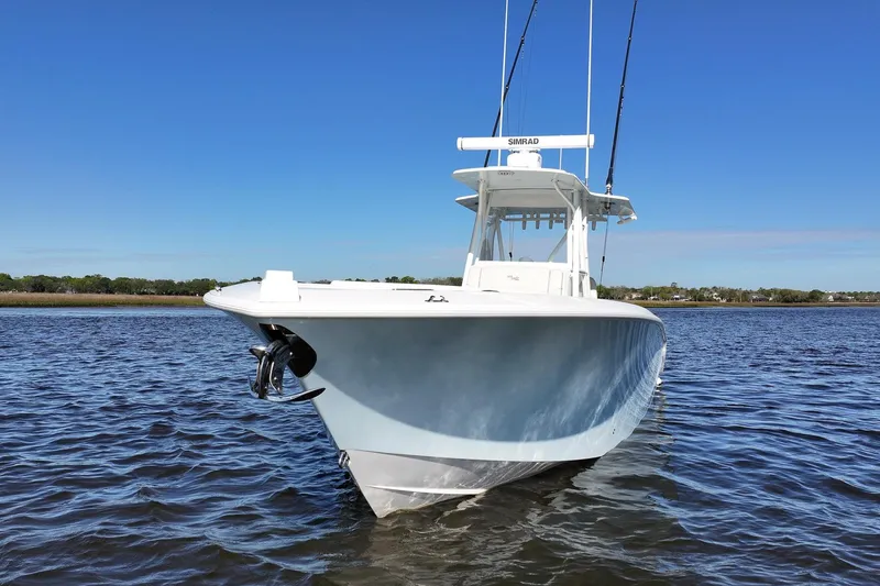 Slide: The Image of 2022 SeaVee 322Z boat on calm water under clear blue sky. - 3
