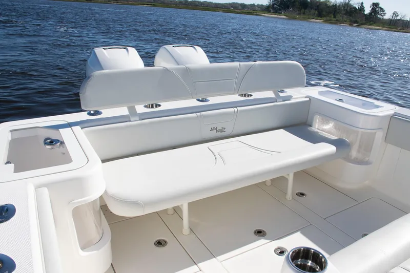 Slide: The Image of 2022 SeaVee 322Z boat interior with seating and storage, overlooking calm water. - 32