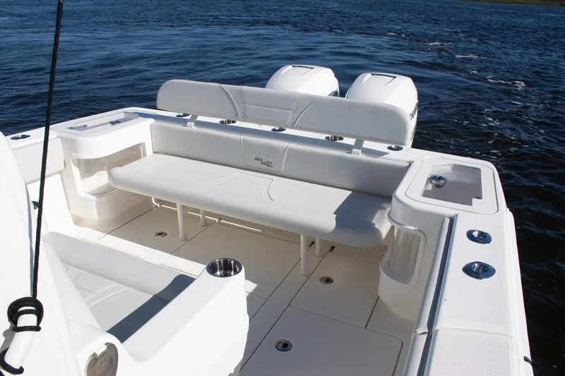 Slide: The Image of 2022 SeaVee 322Z boat interior with white seating and twin engines on the water. - 34