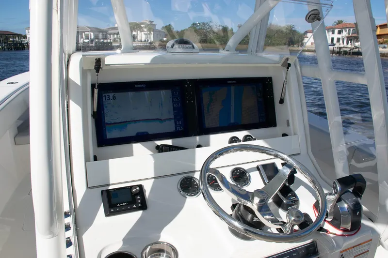 Slide: The Image of 2022 SeaVee 322Z boat dashboard with navigation screens and steering wheel. - 35