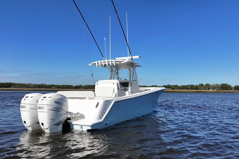 Slide: The Image of 2022 SeaVee 322Z boat with dual Mercury 350 engines on calm water. - 4