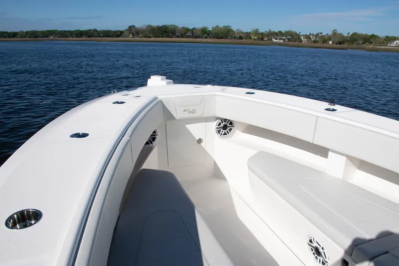 Slide: The Image of 2022 SeaVee 322Z boat interior with seating, on calm water. - 40