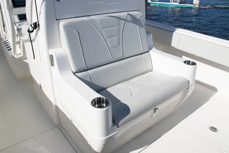 Slide: The Image of 2022 SeaVee 322Z boat deck with rod holders, docked by calm waters. - 42