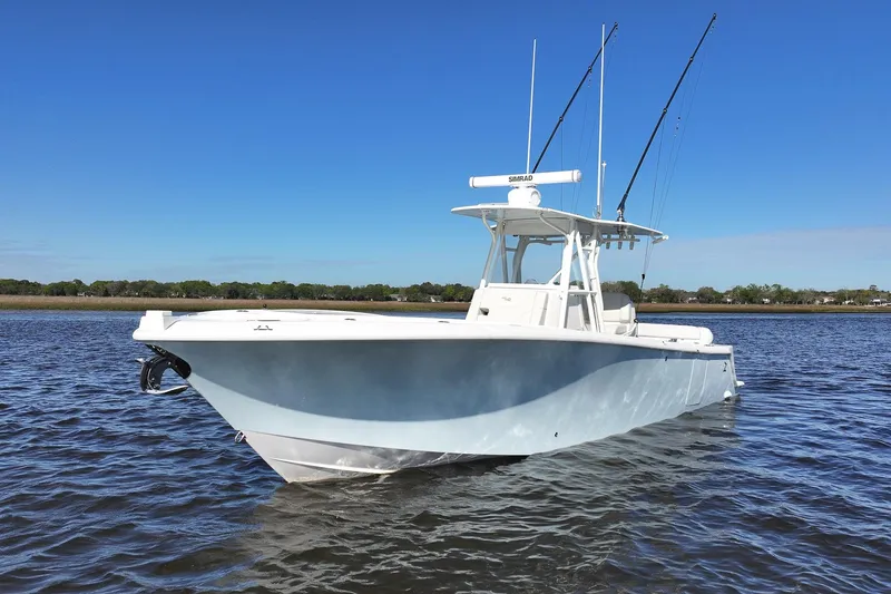 Slide: The Image of 2022 SeaVee 322Z boat on calm water under clear blue sky. - 5