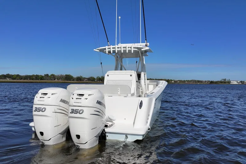 Slide: The Image of 2022 SeaVee 322Z boat with twin Mercury 350 engines on a calm water body. - 6