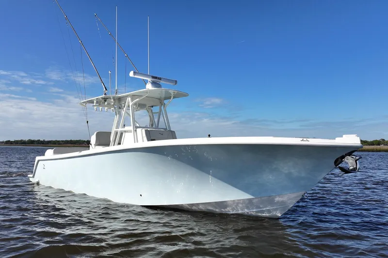 Slide: The Image of 2022 SeaVee 322Z boat on calm water under clear blue sky. - 7