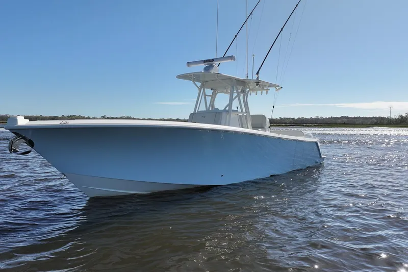 Slide: The Image of 2022 SeaVee 322Z boat on calm water under clear blue sky. - 8