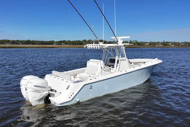 Slide: The Image of 2022 SeaVee 322Z boat with dual Mercury engines on calm water. - 9