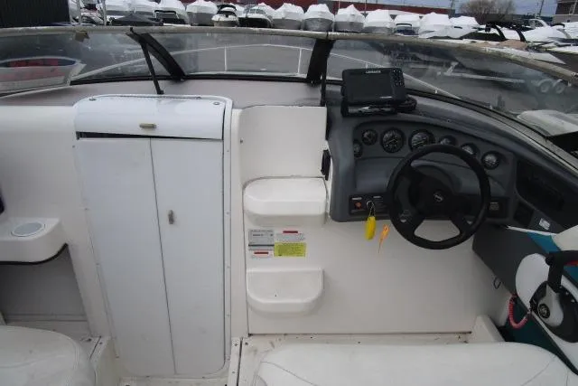 Slide: The Image of 1995 Wellcraft 236 Eclipse boat cockpit with steering wheel and control panel. - 11