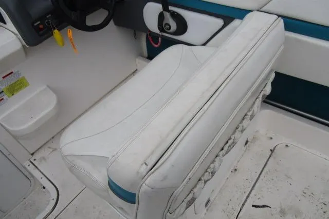 Slide: The Image of 1995 Wellcraft 236 Eclipse boat interior with white seating and steering area. - 12
