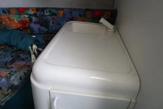 Slide: The Image of Interior of 1995 Wellcraft 236 Eclipse boat with compact sink and colorful seating. - 16