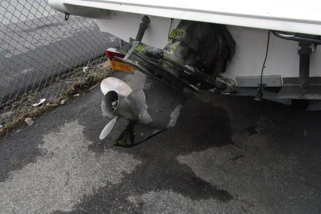 Slide: The Image of 1995 Wellcraft 236 Eclipse boat propeller and stern drive on pavement. - 20