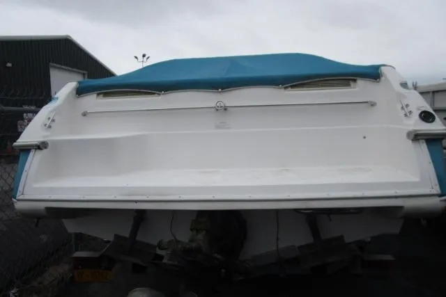 Slide: The Image of 1995 Wellcraft 236 Eclipse boat with blue cover, docked in a marina. - 3