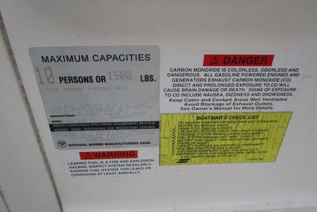 Slide: The Image of 1995 Wellcraft 236 Eclipse capacity and safety warning labels on boat interior. - 6