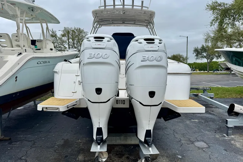 Slide: The Image of 2013 Intrepid 327 Cuddy boat with twin 300 horsepower engines, docked outdoors. - 5