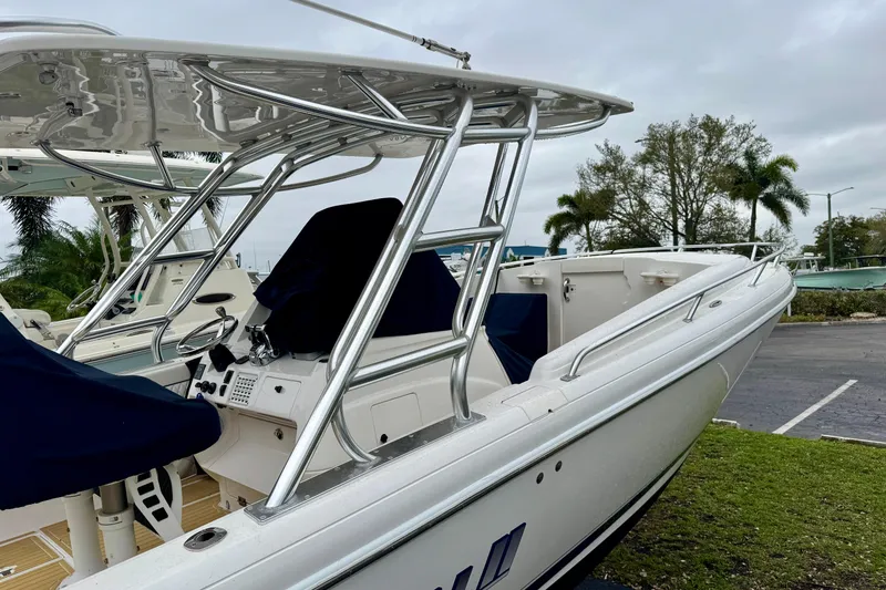 Slide: The Image of 2013 Intrepid 327 Cuddy boat with sleek design and covered seating area. - 7