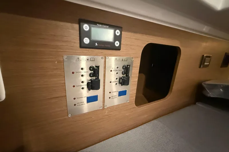 Slide: The Image of Control panel on 2020 Jeanneau NC 1095 boat interior, featuring electrical switches and display. - 11
