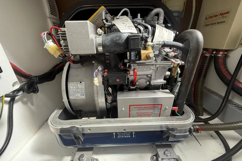 Slide: The Image of Engine compartment of a 2020 Jeanneau NC 1095 boat, featuring a Fischer Panda generator. - 16