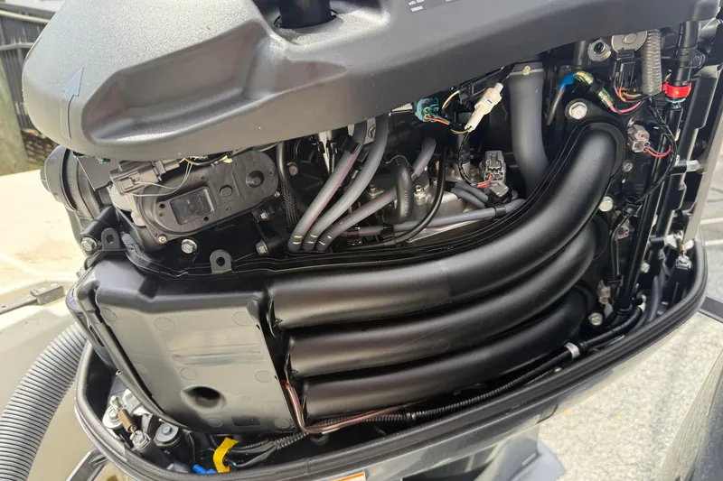 Slide: The Image of Close-up of a 2020 Jeanneau NC 1095 boat engine, showcasing intricate mechanical details. - 17