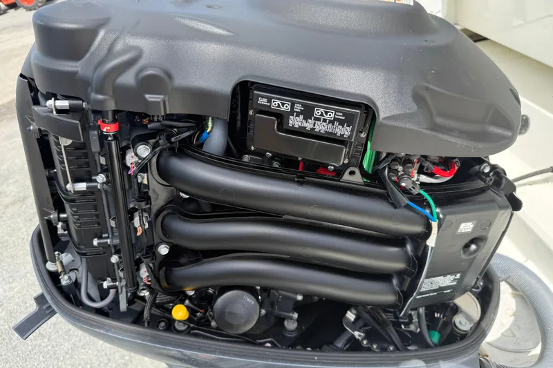 Slide: The Image of Close-up of a 2020 Jeanneau NC 1095 boat engine, showcasing intricate mechanical components. - 18