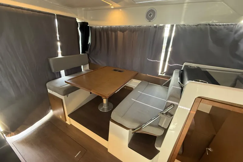 Slide: The Image of Interior of 2020 Jeanneau NC 1095 boat with dining area and seating. - 2