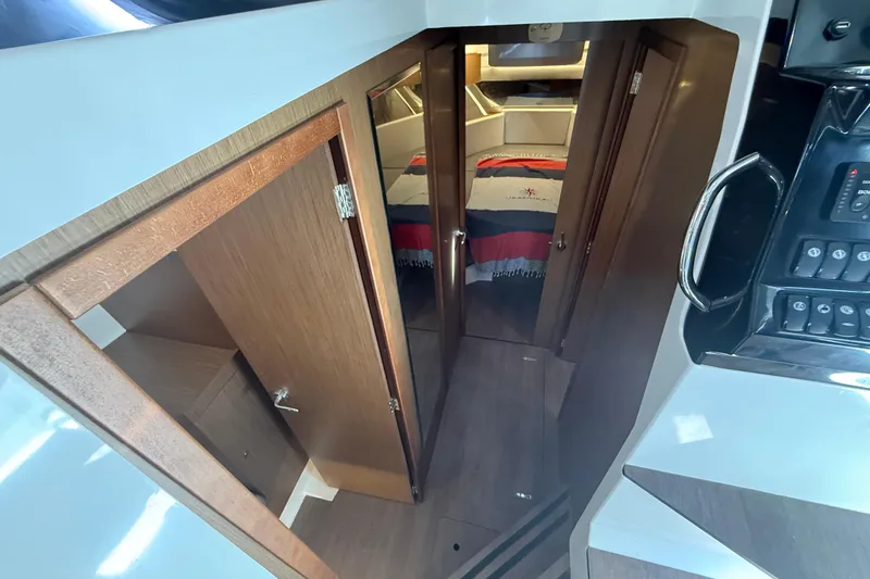 Slide: The Image of 2020 Jeanneau NC 1095 interior cabin with wooden doors and cozy bed. - 4