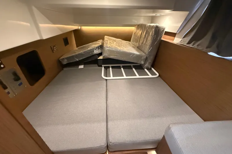 Slide: The Image of 2020 Jeanneau NC 1095 cabin interior with convertible seating and modern design. - 8