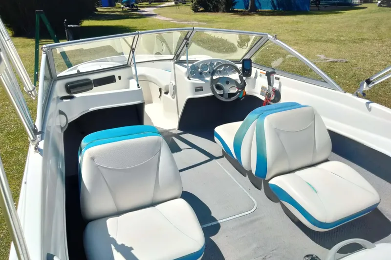 Slide: The Image of 2007 Bayliner 175 Bowrider interior with white and blue seating, steering wheel, and dashboard. - 12
