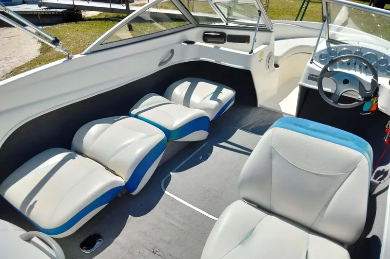 Slide: The Image of 2007 Bayliner 175 Bowrider interior with white and blue seating, steering wheel, and dashboard. - 17