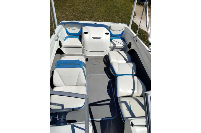 Slide: The Image of 2007 Bayliner 175 Bowrider interior with white and blue seating, spacious layout. - 18