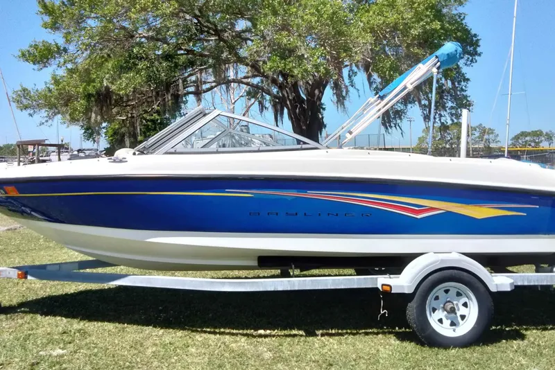 Slide: The Image of 2007 Bayliner 175 Bowrider boat on trailer, parked on grass under a tree. - 20