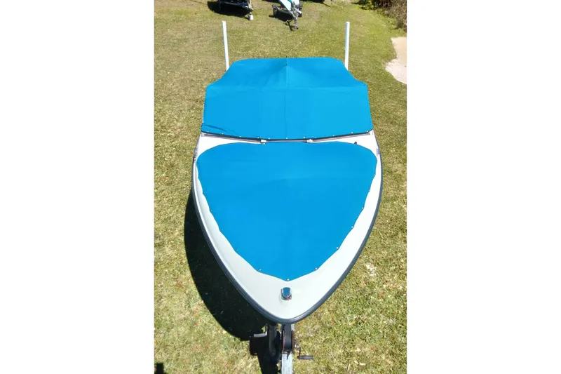 Slide: The Image of 2007 Bayliner 175 Bowrider with blue cover on grass. - 22