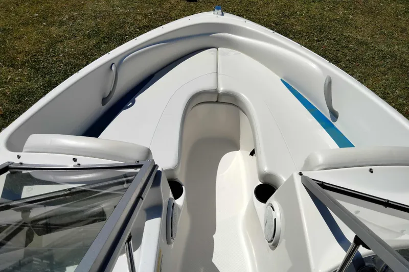 Slide: The Image of 2007 Bayliner 175 Bowrider boat interior with white seating and blue accents. - 6
