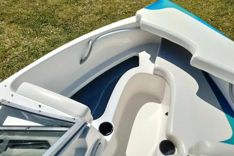Slide: The Image of 2007 Bayliner 175 Bowrider interior with white seating and cup holders. - 7