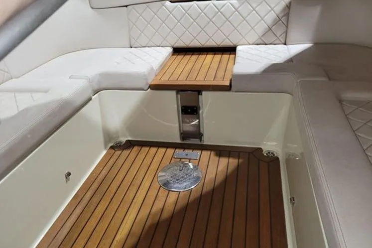 Slide: The Image of Interior of 2018 Chris-Craft Launch 34 with teak flooring and white quilted seating. - 16