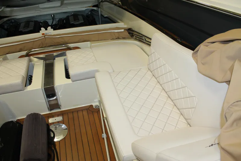 Slide: The Image of 2018 Chris-Craft Launch 34 interior with white quilted seating and teak flooring. - 18