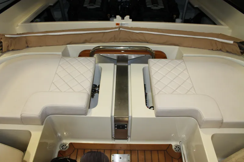 Slide: The Image of 2018 Chris-Craft Launch 34 interior with white quilted seating and teak flooring. - 19