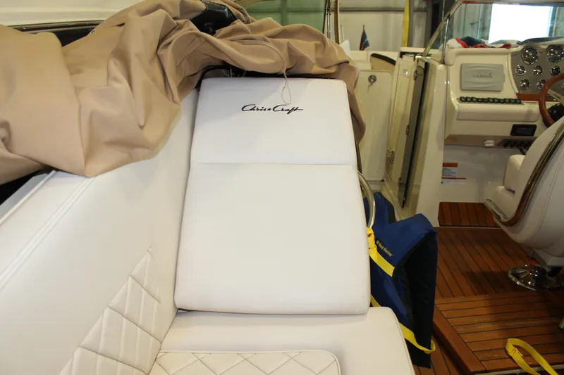 Slide: The Image of 2018 Chris-Craft Launch 34 interior with white seating and wooden flooring. - 20