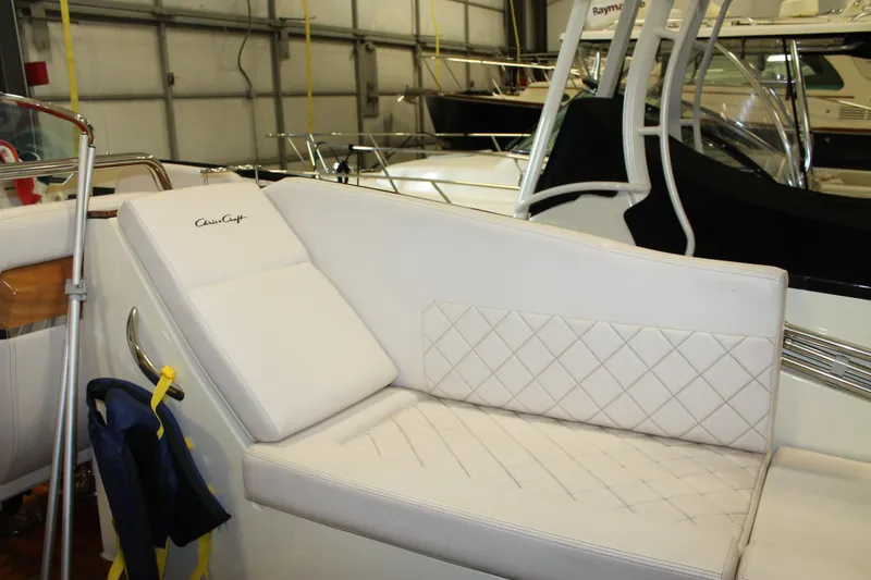 Slide: The Image of 2018 Chris-Craft Launch 34 boat interior with white cushioned seating. - 23