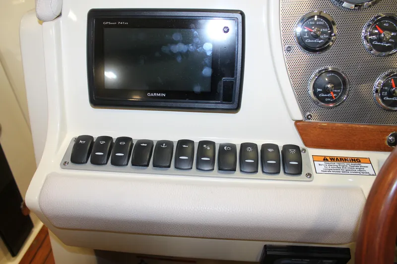 Slide: The Image of 2018 Chris-Craft Launch 34 dashboard with Garmin GPS and control switches. - 26