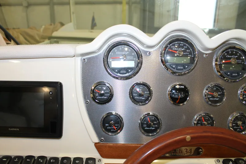 Slide: The Image of Dashboard of a 2018 Chris-Craft Launch 34 boat with gauges and Garmin display. - 28