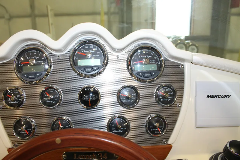 Slide: The Image of Dashboard of a 2018 Chris-Craft Launch 34 boat with gauges and Mercury branding. - 29