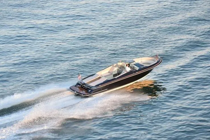 Slide: The Image of 2018 Chris-Craft Launch 34 cruising on open water, showcasing sleek design and performance. - 3