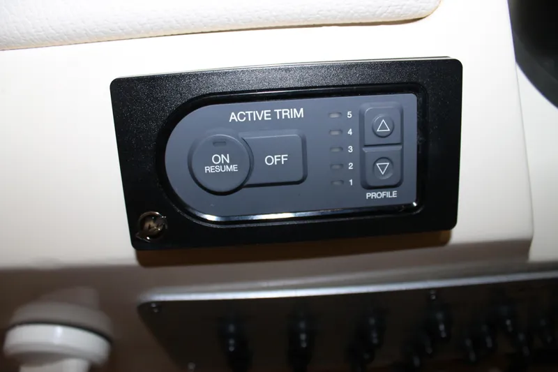 Slide: The Image of Active trim control panel on 2018 Chris-Craft Launch 34 boat dashboard. - 34