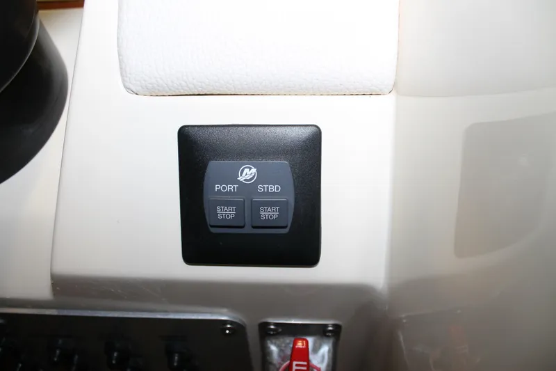 Slide: The Image of Control panel of a 2018 Chris-Craft Launch 34 boat with start-stop buttons. - 35