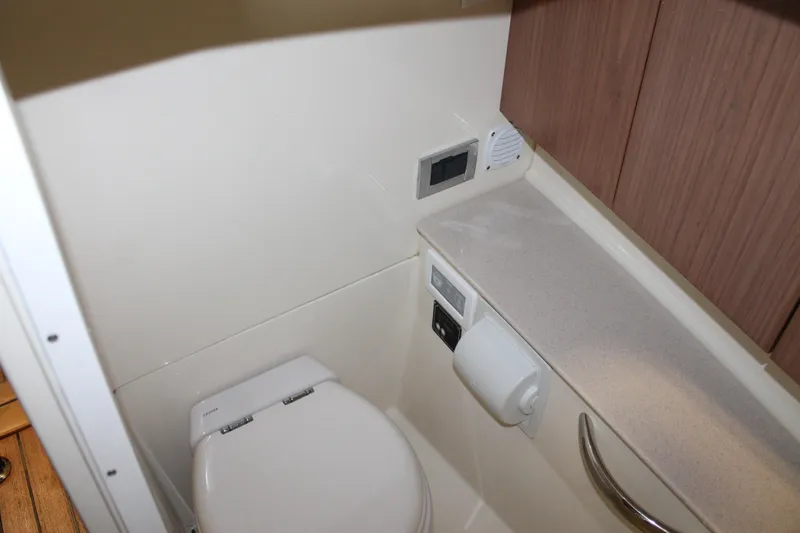 Slide: The Image of 2018 Chris-Craft Launch 34 boat bathroom with toilet and wooden cabinetry. - 38