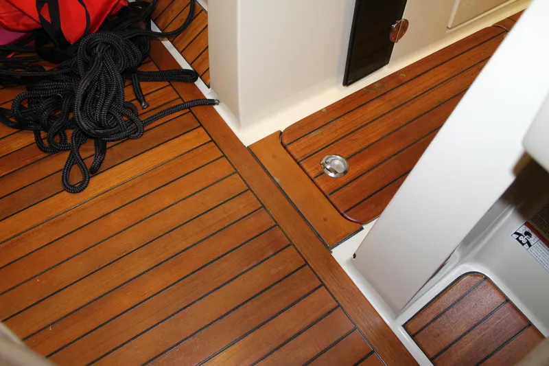 Slide: The Image of 2018 Chris-Craft Launch 34 interior with teak flooring and coiled rope. - 39