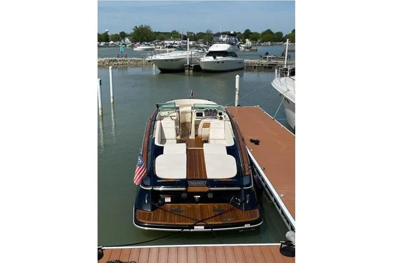 Slide: The Image of 2018 Chris-Craft Launch 34 docked at marina, showcasing elegant design and luxury features. - 4
